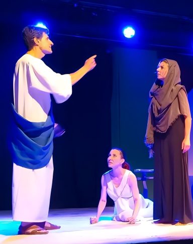 "Las troyanas" de Eurípides Actriz sobre el suelo, compungida, representando a una troyana de la obra de Eurípides "Las troyanas".